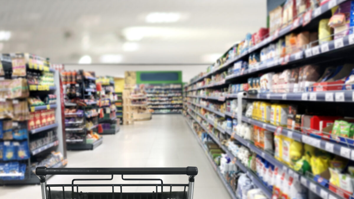 choosing a dairy products at supermarket.empty grocery cart in an empty supermarket