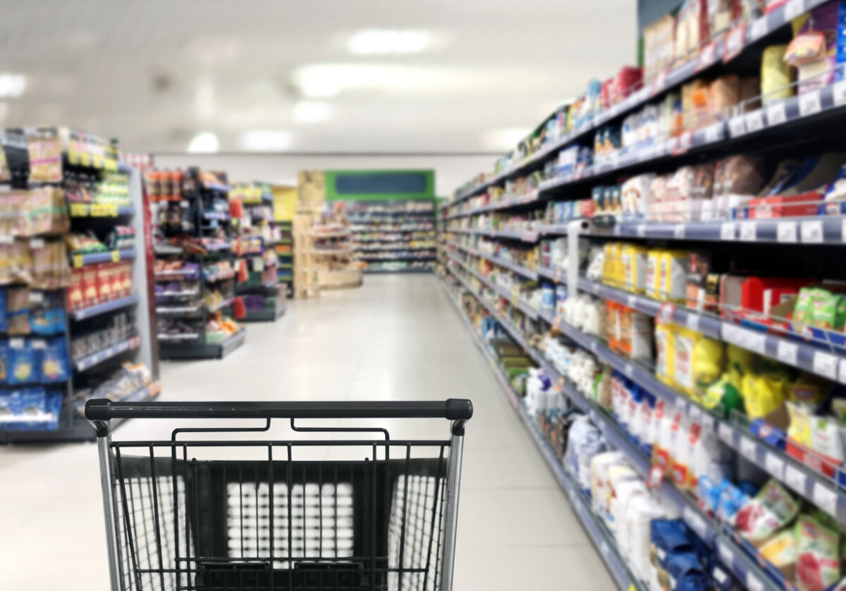 choosing a dairy products at supermarket.empty grocery cart in an empty supermarket