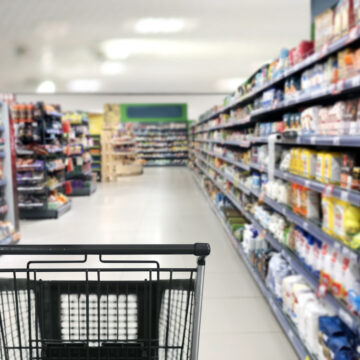 choosing a dairy products at supermarket.empty grocery cart in an empty supermarket