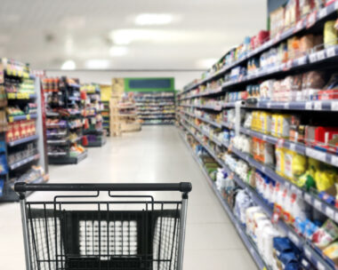 choosing a dairy products at supermarket.empty grocery cart in an empty supermarket