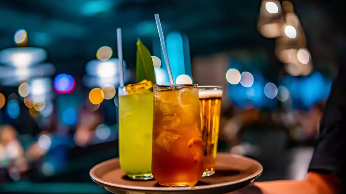 glasses alcohol cocktail set and beer on a waiter tray in bar