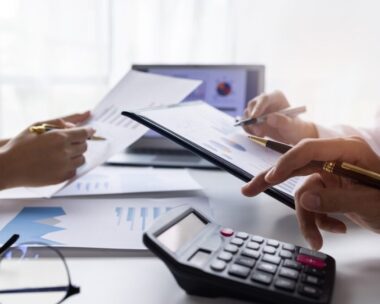 Team of Business people working at workplace with tablet and document, doing planning analyzing Tax financial report, business plan investment, finance analysis Economic business discussions