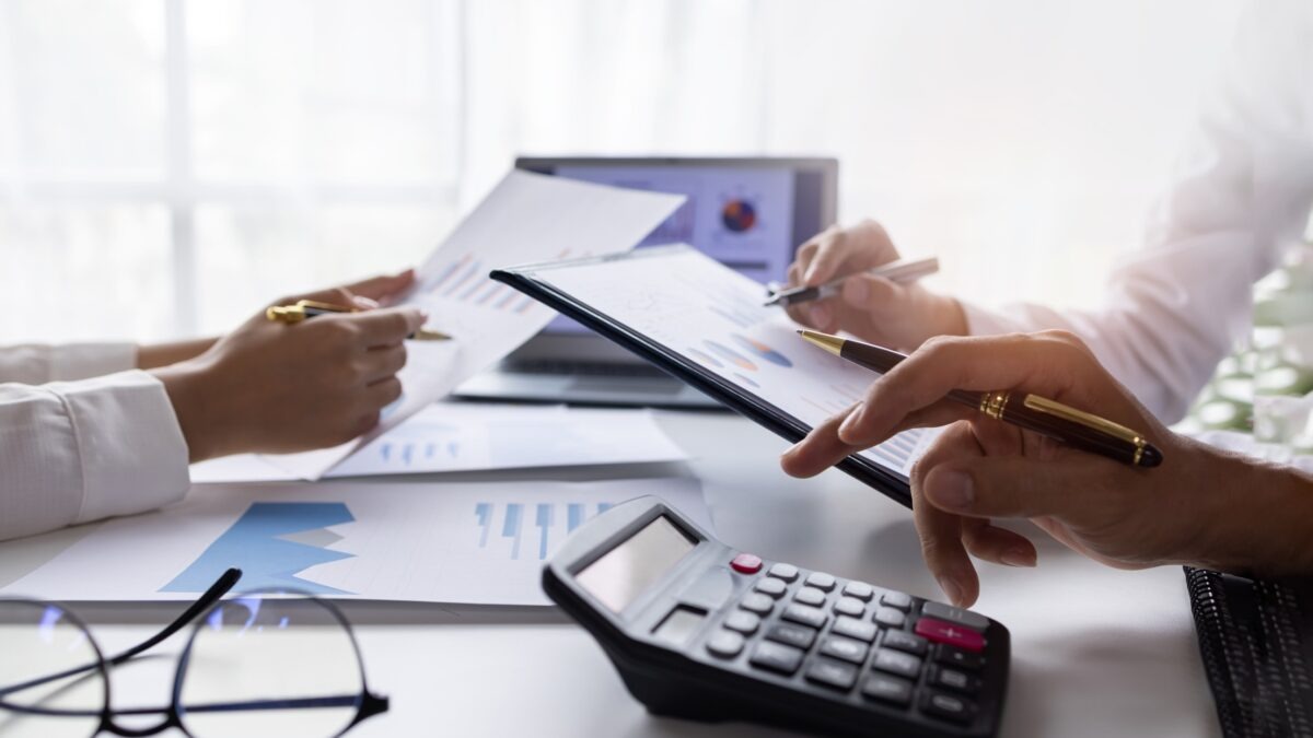 Team of Business people working at workplace with tablet and document, doing planning analyzing Tax financial report, business plan investment, finance analysis Economic business discussions