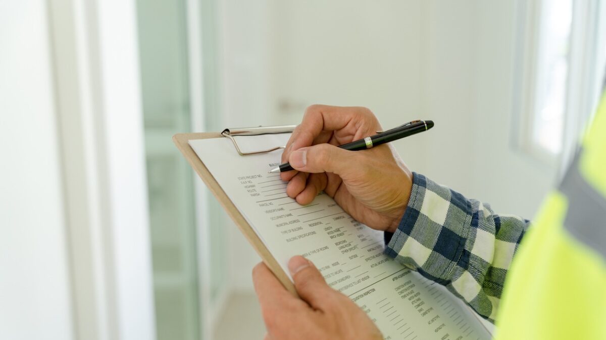inspector or engineer is inspecting construction and quality assurance new house using a checklist. Engineers or architects or contactor work to build the house before handing it over to the homeowner