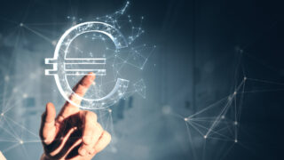 Close up of male hand pointing at creative polygonal euro sign on gray wall background. Online banking, money and trade concept