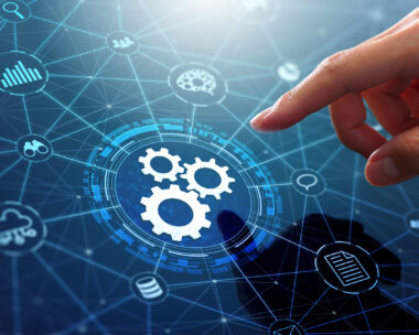 Businessman touching gears icon on network connection.