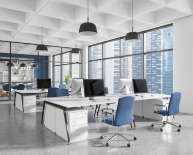 Contemporary office interior with ergonomic furniture, blue chairs, desks, and computers in a spacious area with large windows. Concept of workspace design. 3D Rendering