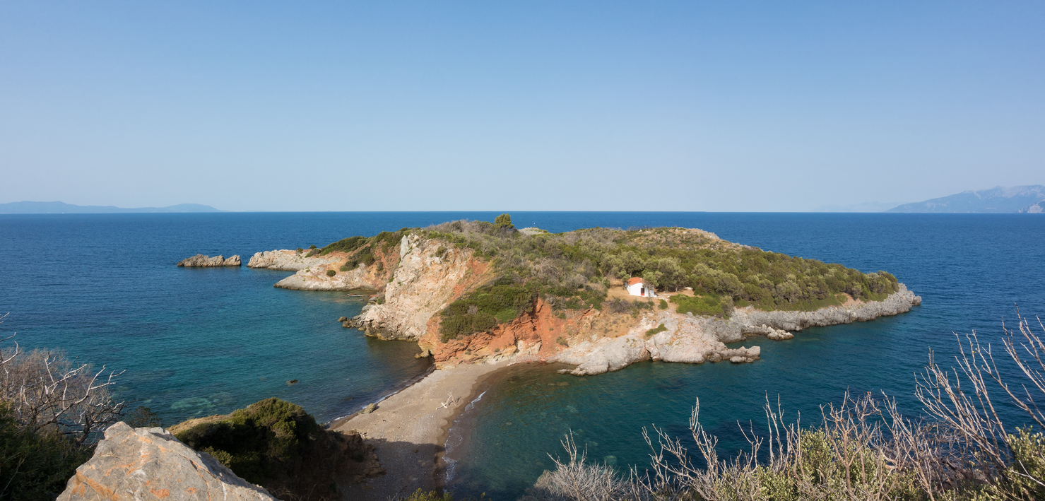 The beautiful bay of Saint Vasilios in North Evia, Greece, with the peninsula and the small white church