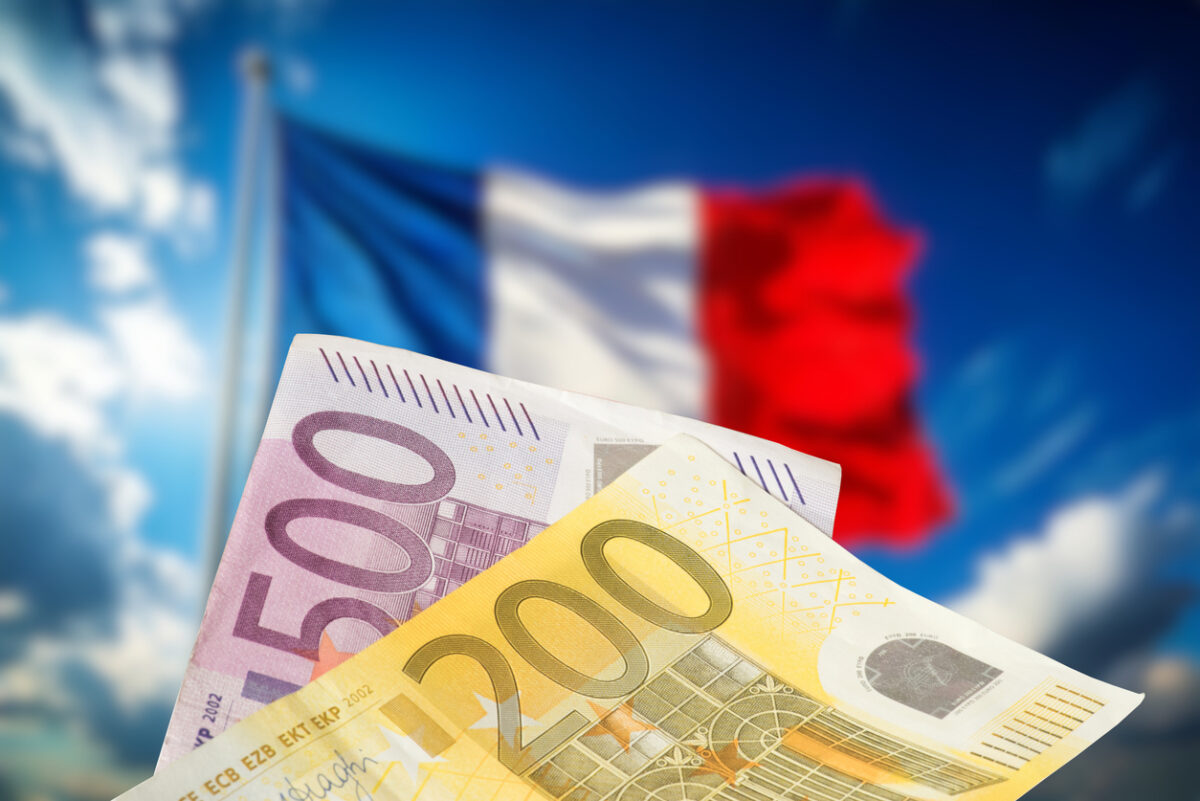 Flags of France and money Euro banknotes