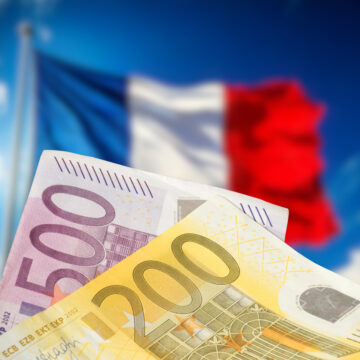 Flags of France and money Euro banknotes