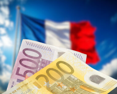 Flags of France and money Euro banknotes