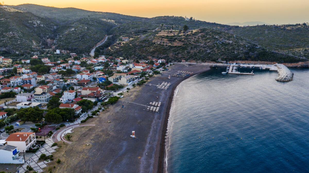 Agia Anna Evia, Greece June 22, 2025: The beach of Agia Anna on Evia's northeast coast features sunbeds, umbrellas, and a lifeguard tower under clear skies.