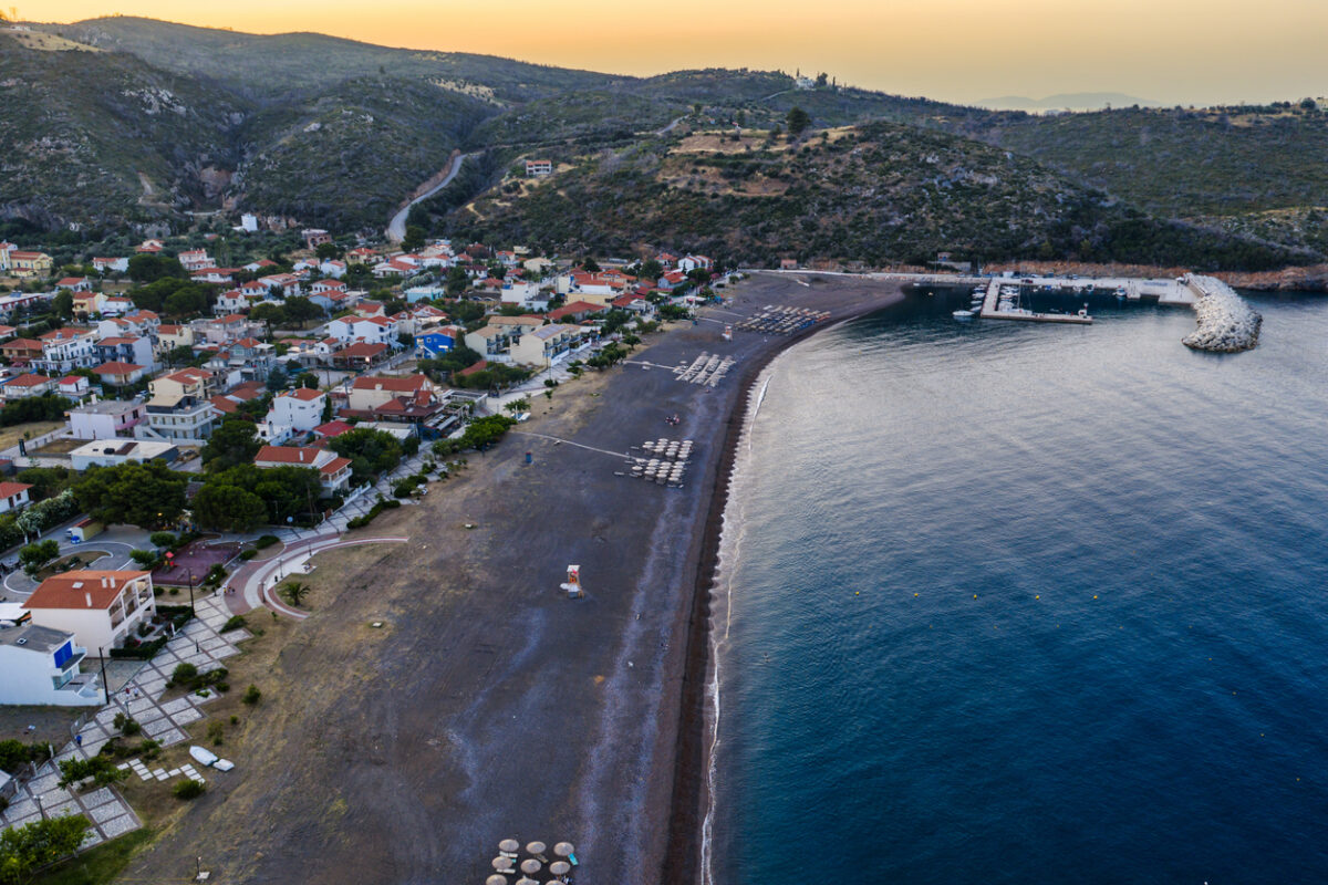 Agia Anna Evia, Greece June 22, 2025: The beach of Agia Anna on Evia's northeast coast features sunbeds, umbrellas, and a lifeguard tower under clear skies.