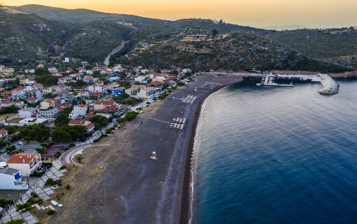Agia Anna Evia, Greece June 22, 2025: The beach of Agia Anna on Evia's northeast coast features sunbeds, umbrellas, and a lifeguard tower under clear skies.