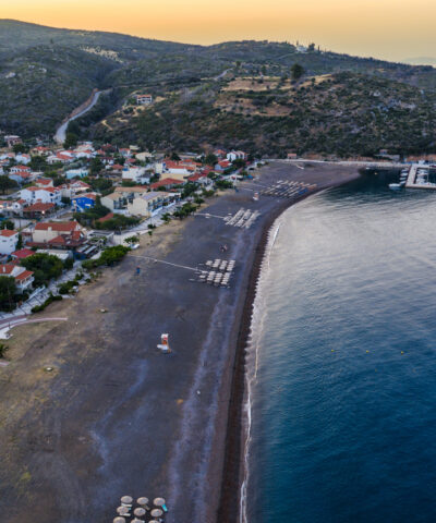 Agia Anna Evia, Greece June 22, 2025: The beach of Agia Anna on Evia's northeast coast features sunbeds, umbrellas, and a lifeguard tower under clear skies.