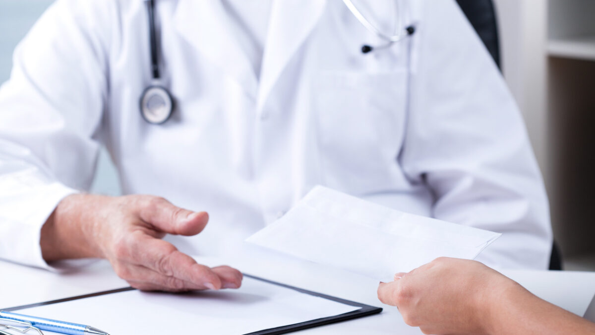 Senior male doctor and payment for private consultation