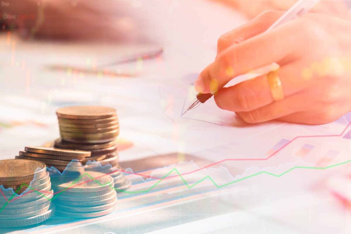 Stack coin money with report finance and banking with profit yong businessmen calculate about cost and stock market or forex graph.
