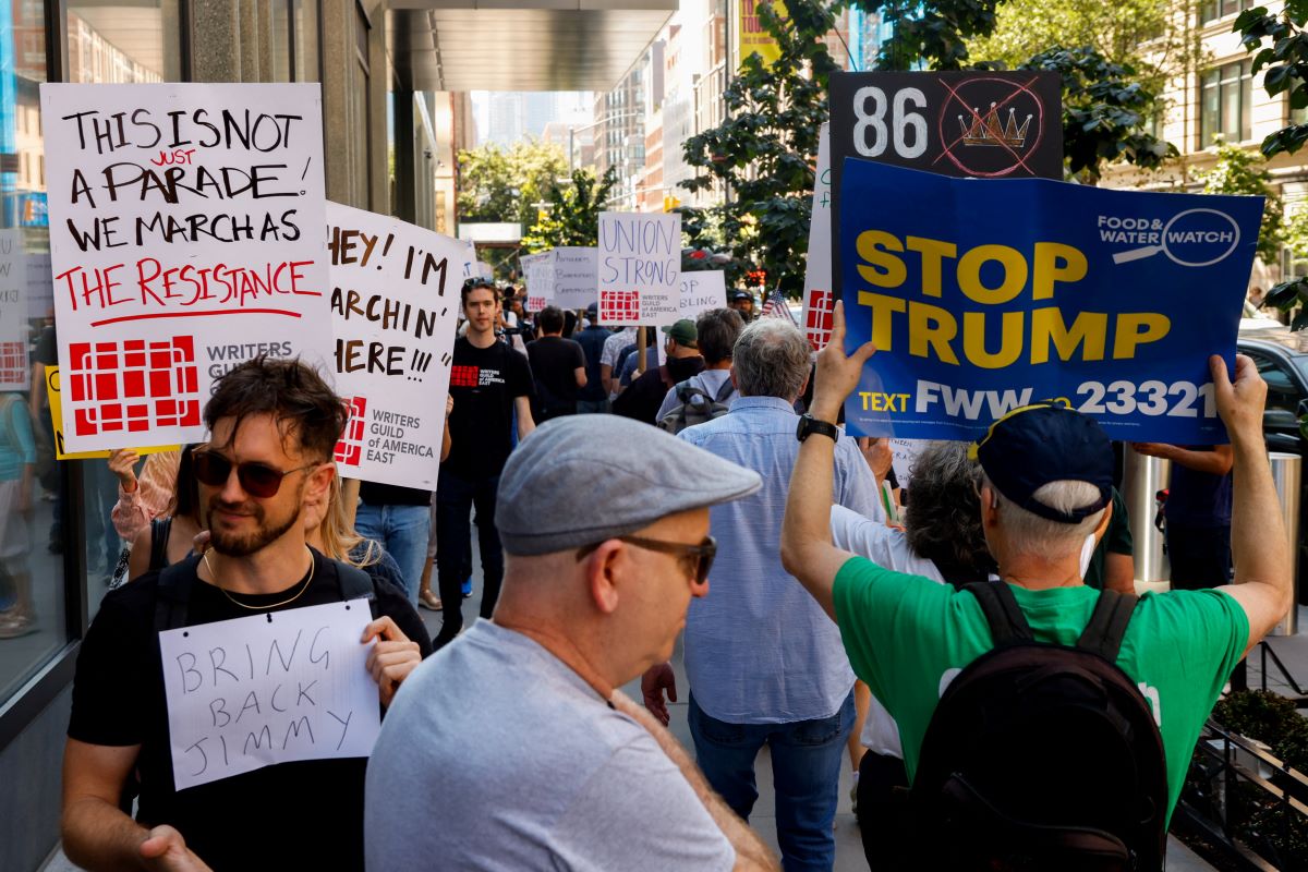 Demonstrators with placards against Trump