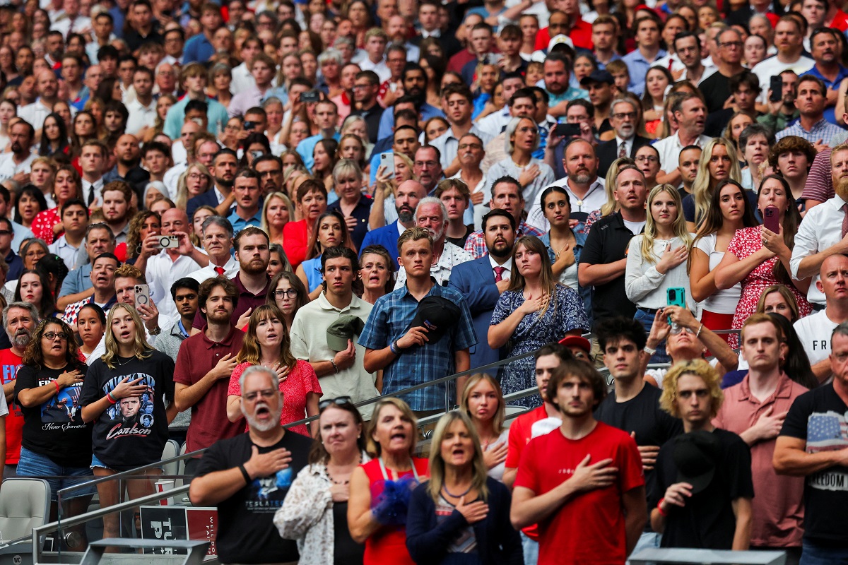 Memorial service for slain conservative commentator Charlie Kirk, in Glendale People stand for the national anthem during the memorial service for slain conservative commentator Charlie Kirk at State Farm Stadium, in Glendale, Arizona, U.S., September 21, 2025. REUTERS/Daniel Cole