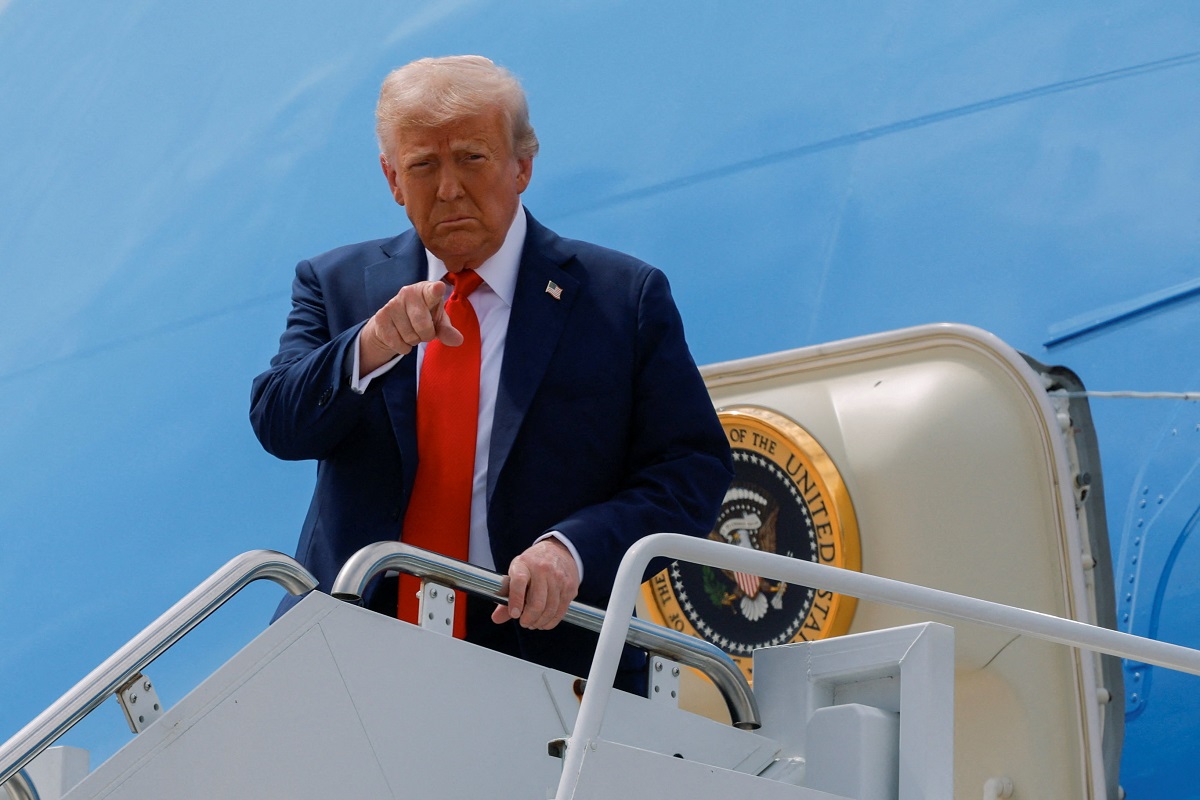 U.S. President Donald Trump gestures while disembarking from Air Force One upon his arrival in Arizona to attend a memorial service for slain conservative commentator Charlie Kirk at State Farm Stadium, at Luke Air Force Base, Arizona, U.S., September 21, 2025.  REUTERS/Brian Snyder