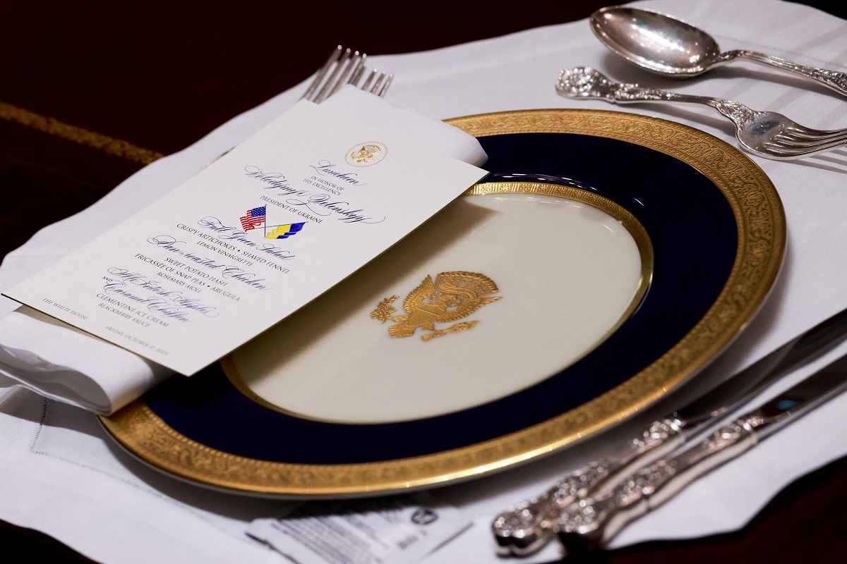 A menu lies next to a plate as U.S. President Donald Trump meets with Ukraine's President Volodymyr Zelenskiy over lunch in the Cabinet Room at the White House in Washington, D.C., U.S., October 17, 2025. REUTERS/Jonathan Ernst