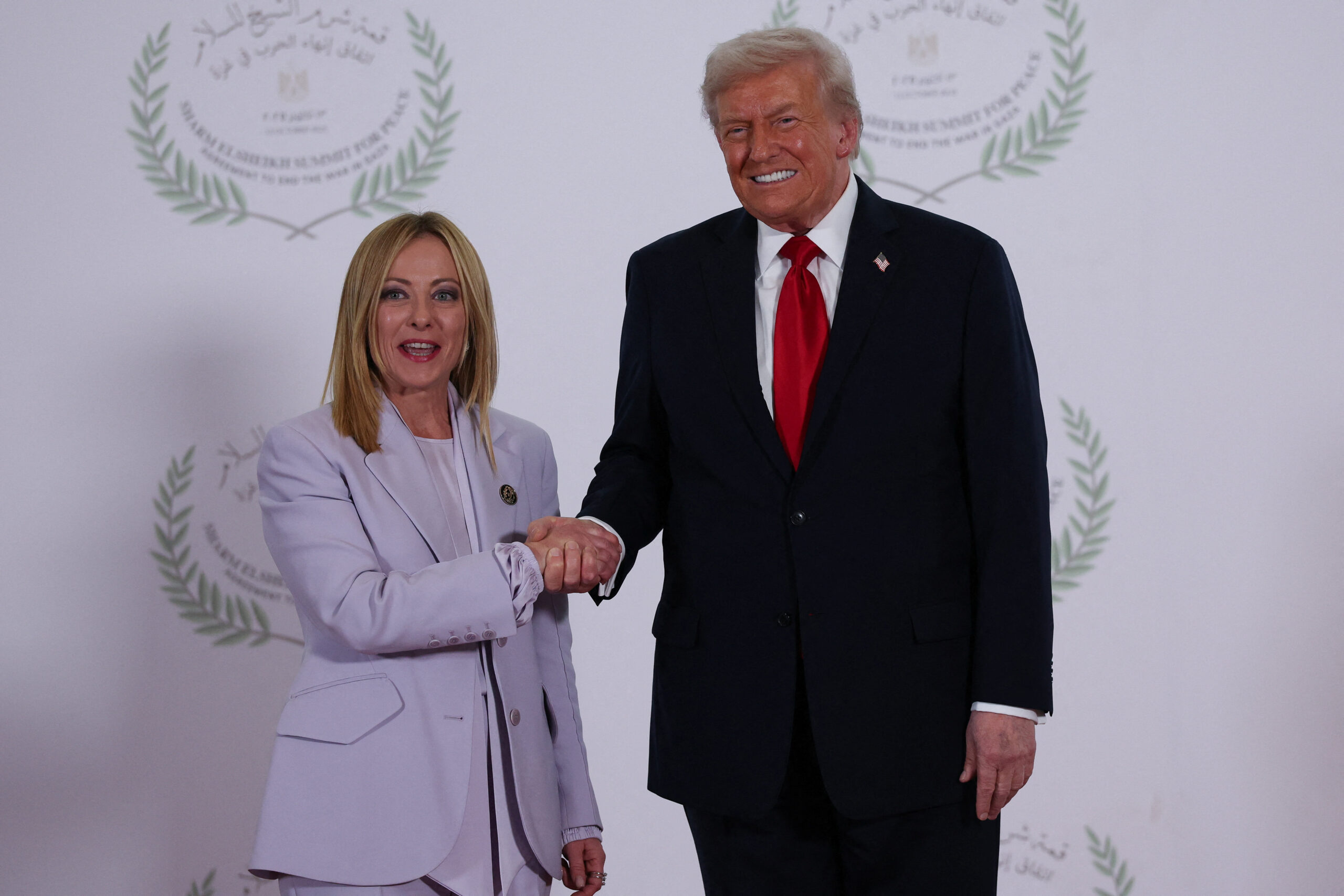 Donald Trump tightens the hand of Italian Prime Minister, Giorgia Meloni