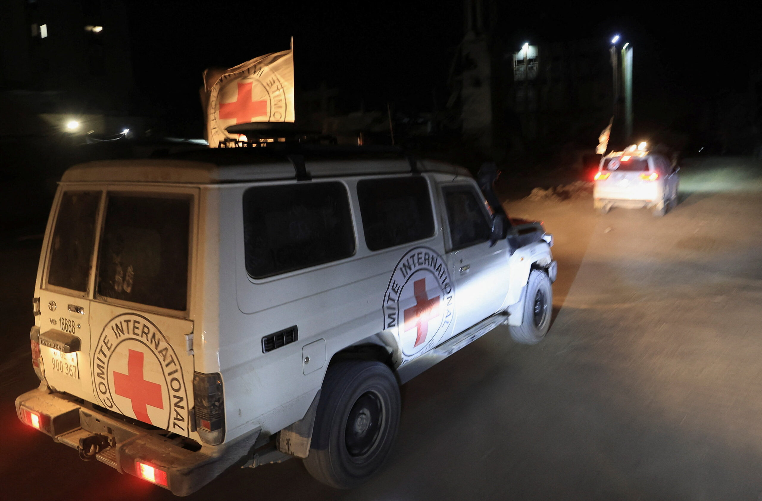 Red Cross cars carry the body of an Israeli hostage