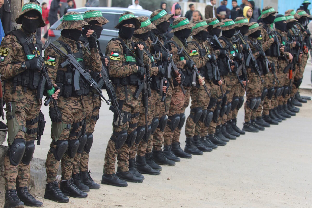 Palestinian Hamas militants stand guard before they release hostages held in Gaza since the deadly October 7, 2023 attack, as part of a ceasefire and a hostages-prisoners swap deal between Hamas and Israel, in Deir Al-Balah in the central Gaza Strip, February 8, 2025. REUTERS