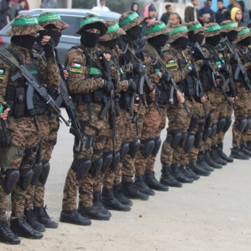 Palestinian Hamas militants stand guard before they release hostages held in Gaza since the deadly October 7, 2023 attack, as part of a ceasefire and a hostages-prisoners swap deal between Hamas and Israel, in Deir Al-Balah in the central Gaza Strip, February 8, 2025. REUTERS
