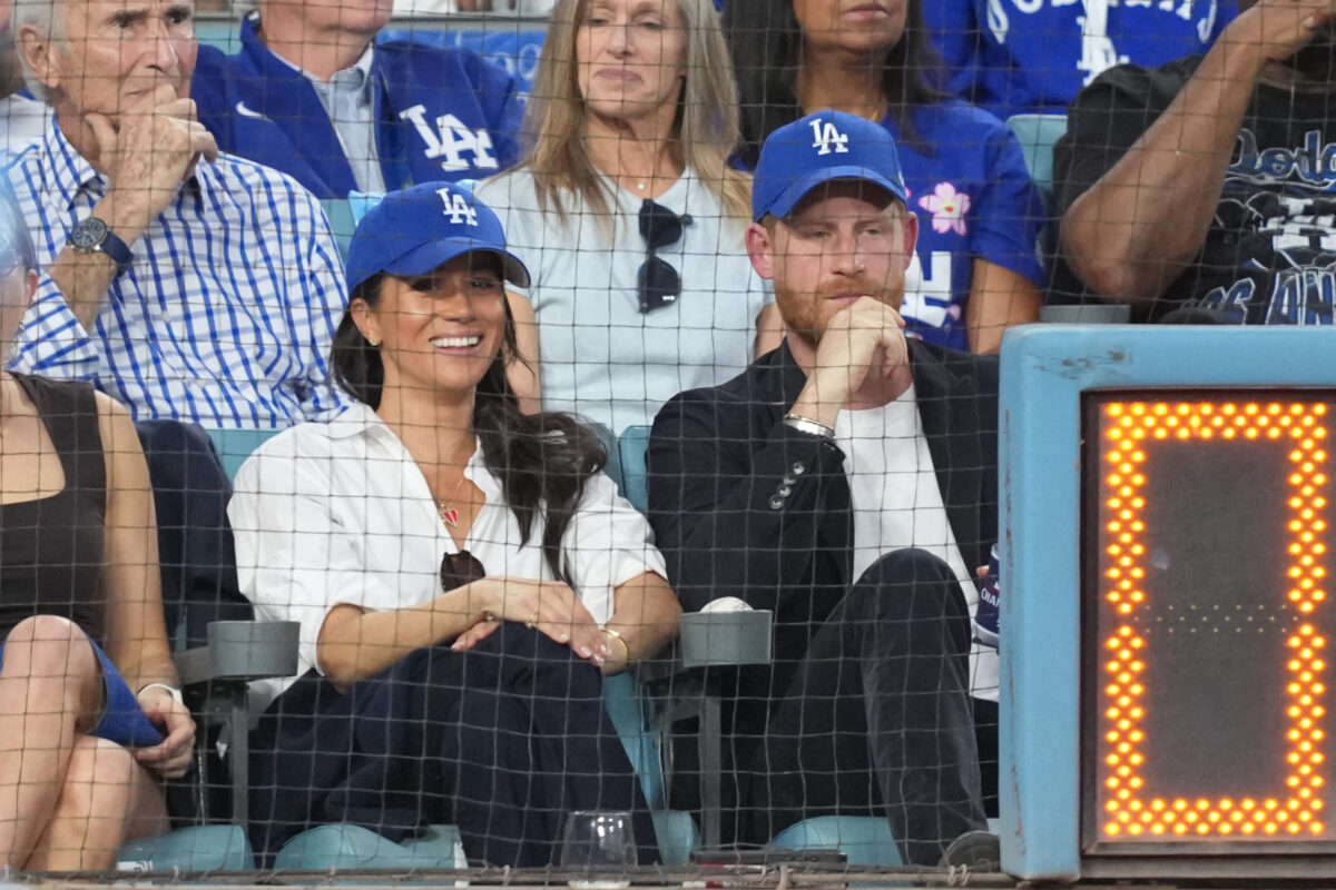 Oct 28, 2025; Los Angeles, California, USA; Prince Harry (right) and Meghan Markle (left) look on in the third inning between the Toronto Blue Jays and the Los Angeles Dodgers during game four of the 2025 MLB World Series at Dodger Stadium. Mandatory Credit: Kirby Lee-Imagn Images