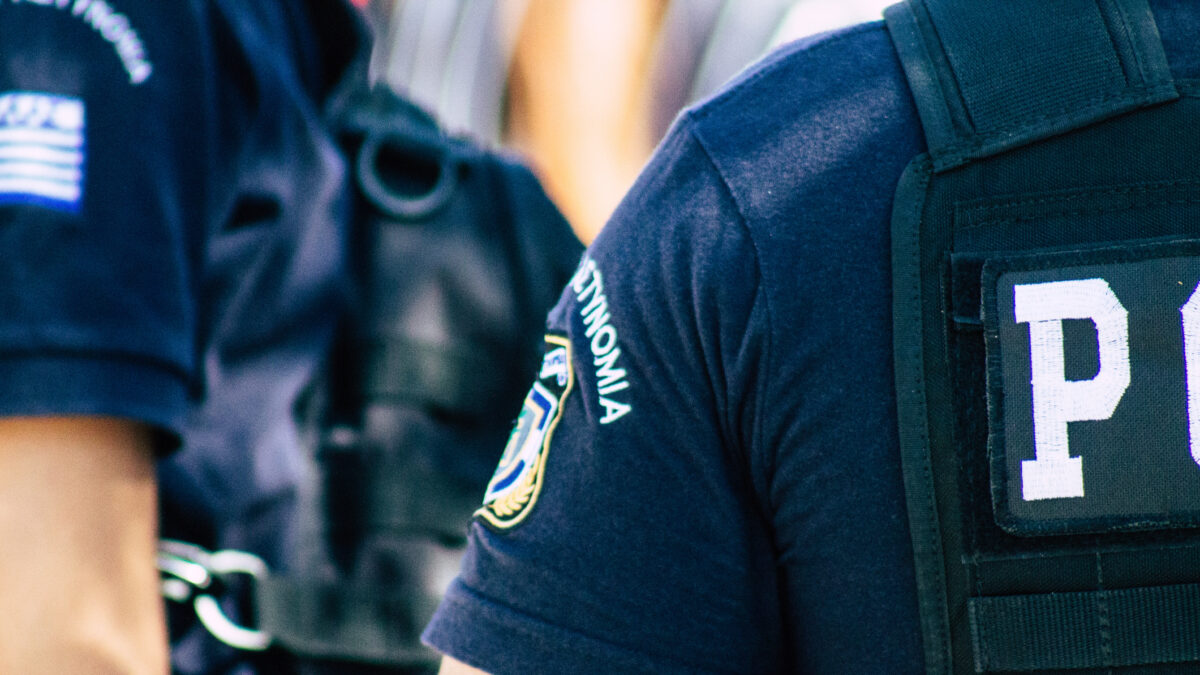 View of Greek police officers standing front the entry of the Acropolis of Athens in the afternoon