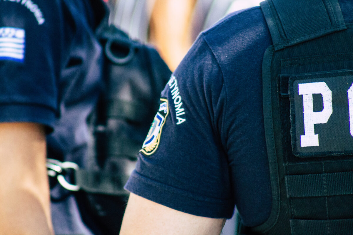 View of Greek police officers standing front the entry of the Acropolis of Athens in the afternoon