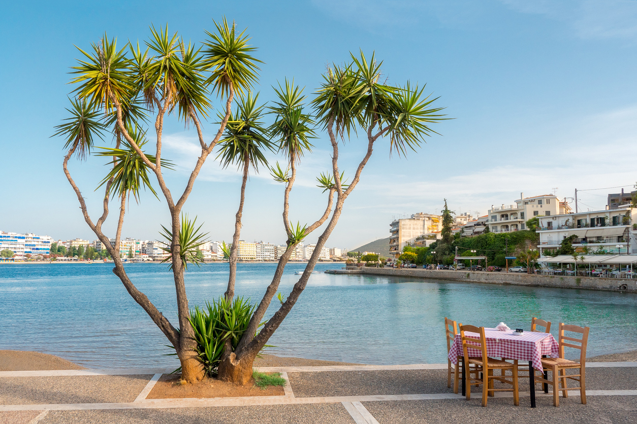 Chalkida, Evia island, Greece. Travel ideas. Greek islands, with its unique beauty, looking out towards the Aegean Sea. Cafe in Chalkida city with view on Aegean sea.