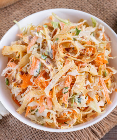 Salad with cabbage and carrots in a white plate on the table