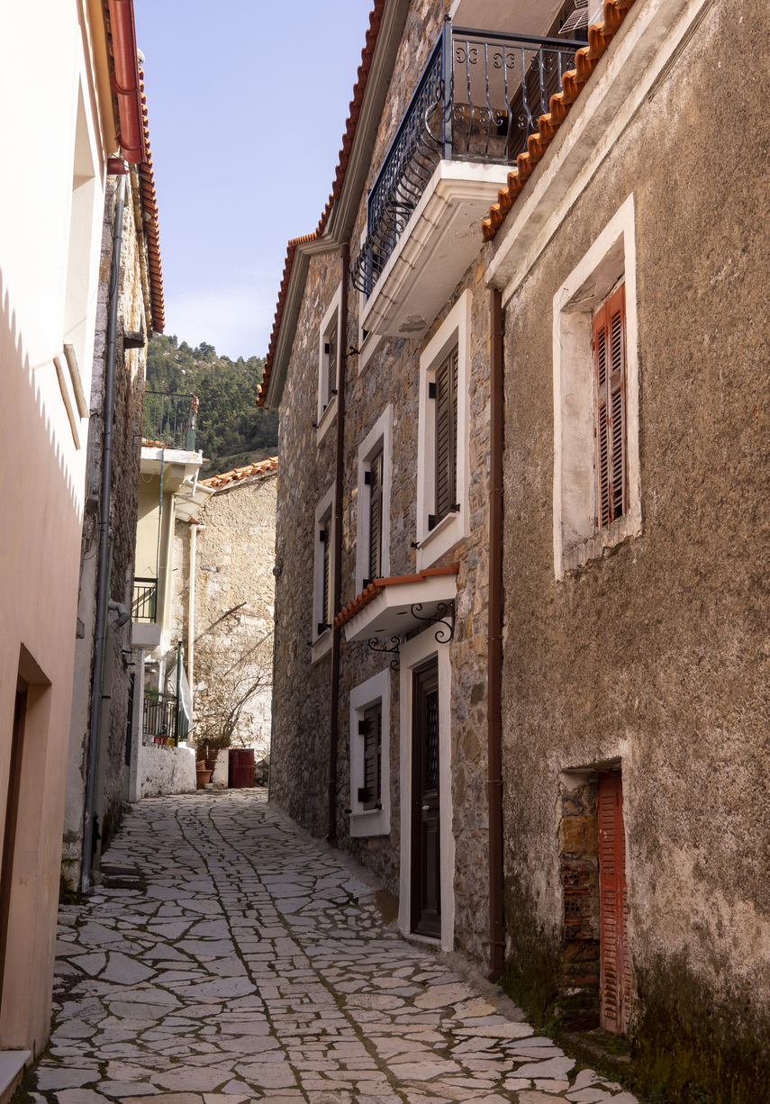 The narrow streets of a Greek village Steni by the mountains Dirfys on the island of Evia , Greece