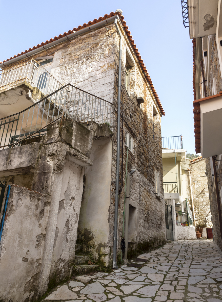 The narrow streets of a Greek village Steni by the mountains Dirfys on the island of Evia , Greece