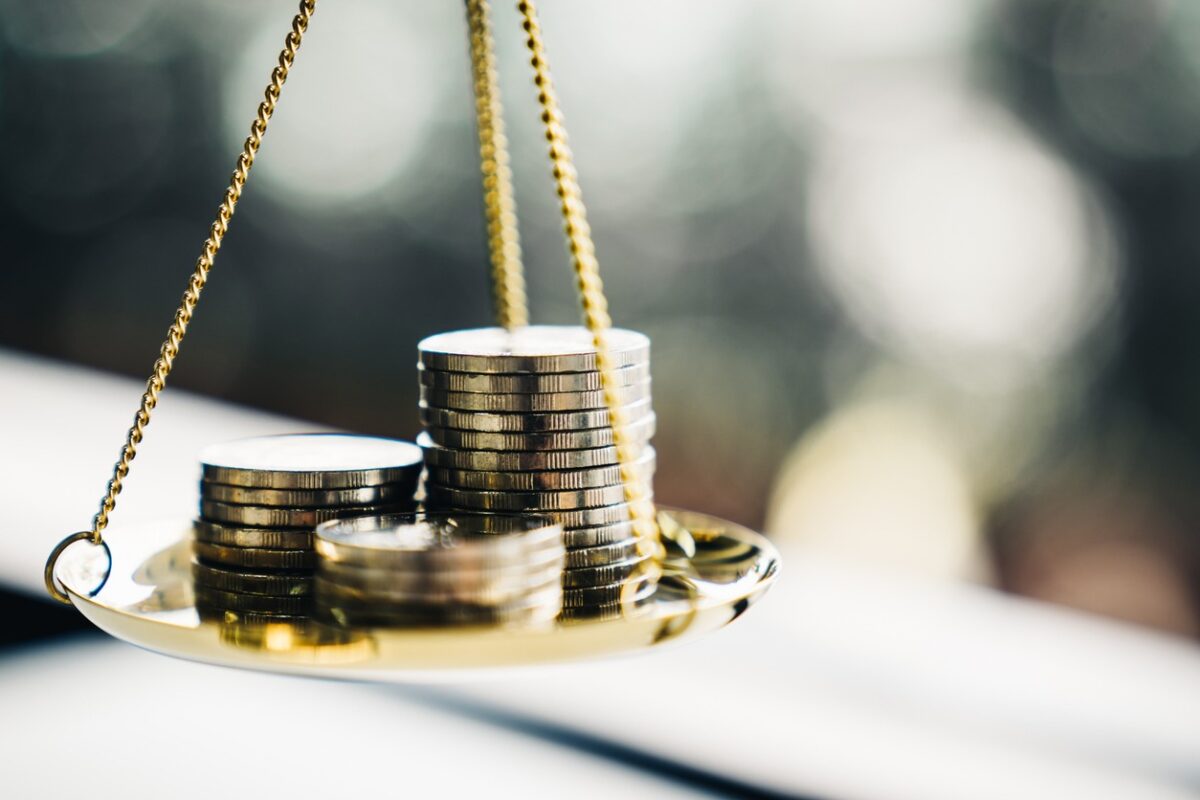 Coins stack with balance scale. Money management, financial plan, time value of money, business idea and Creative ideas for saving money concept