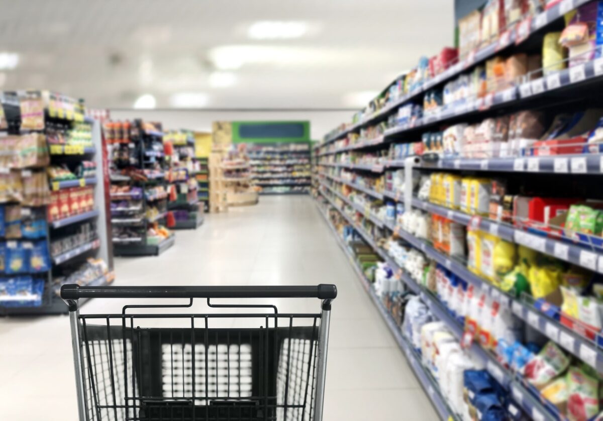 choosing a dairy products at supermarket.empty grocery cart in an empty supermarket