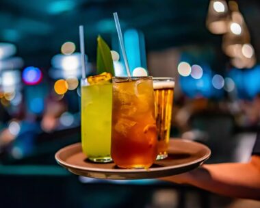 glasses alcohol cocktail set and beer on a waiter tray in bar