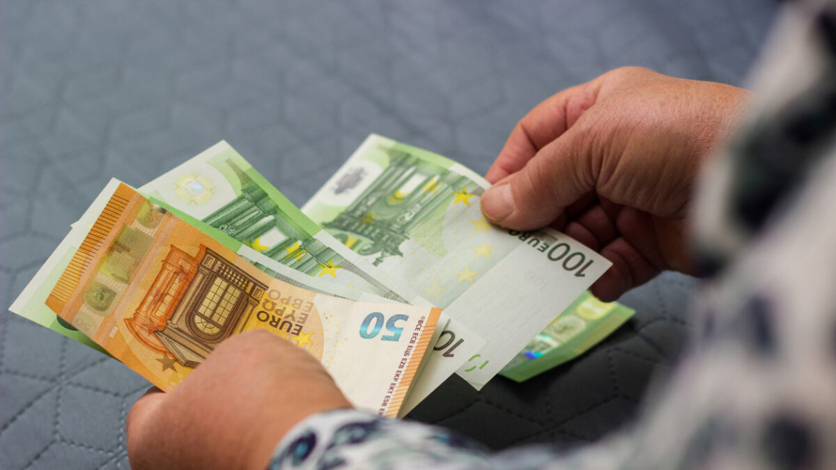 Senior woman hands counting money at home