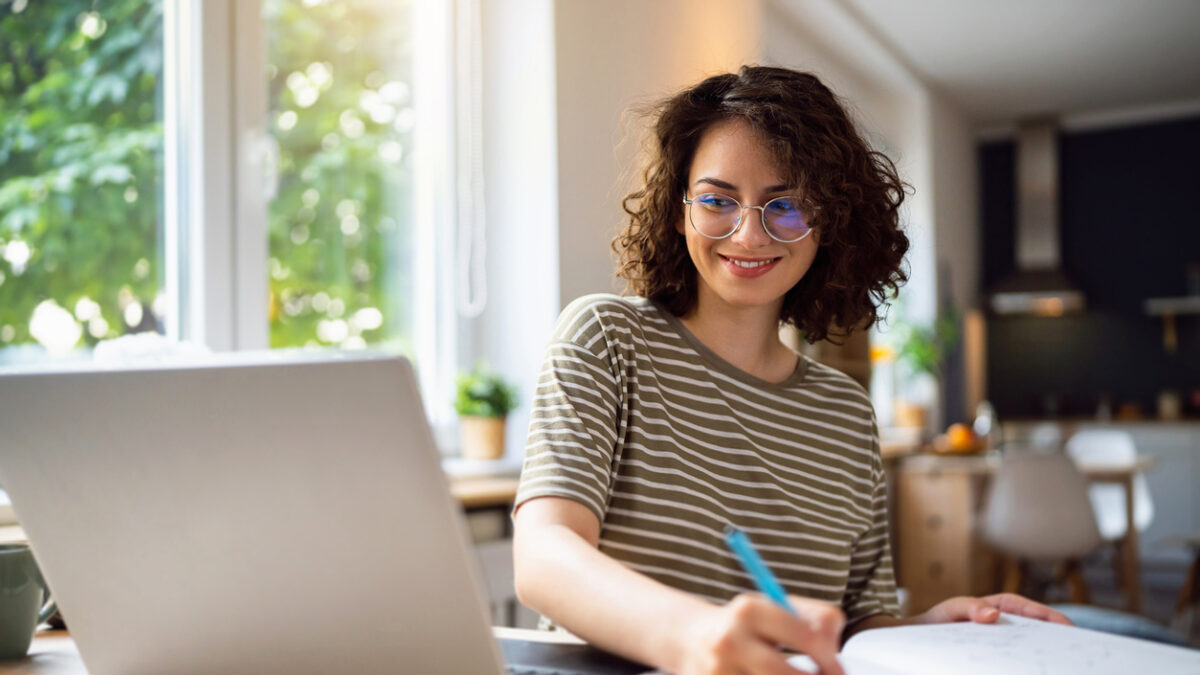 Young woman, a university student, studying online.
