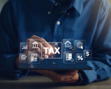 E-tax, A Businessman using a tablet to fill in the income tax online return form for payment.Calculation of tax return.Government, state taxes. Data analysis, paperwork, financial research, reports.