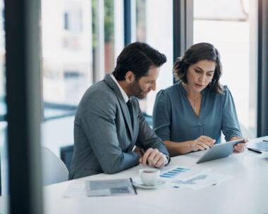Business people, teamwork and tablet for statistics, finance report and planning of revenue, profit or sales in office. Professional advisor or clients with data analytics, graphs and digital charts