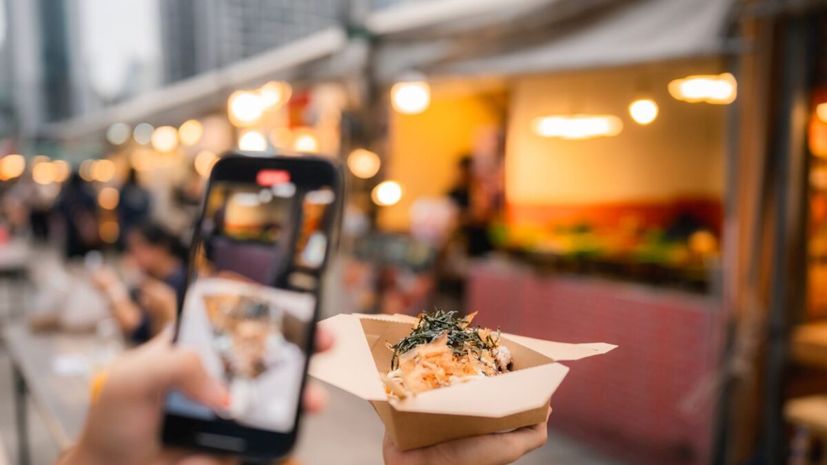 Asian couple eating on the street food at outdoor market