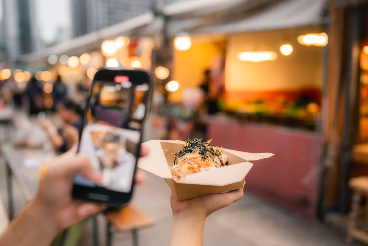 Asian couple eating on the street food at outdoor market