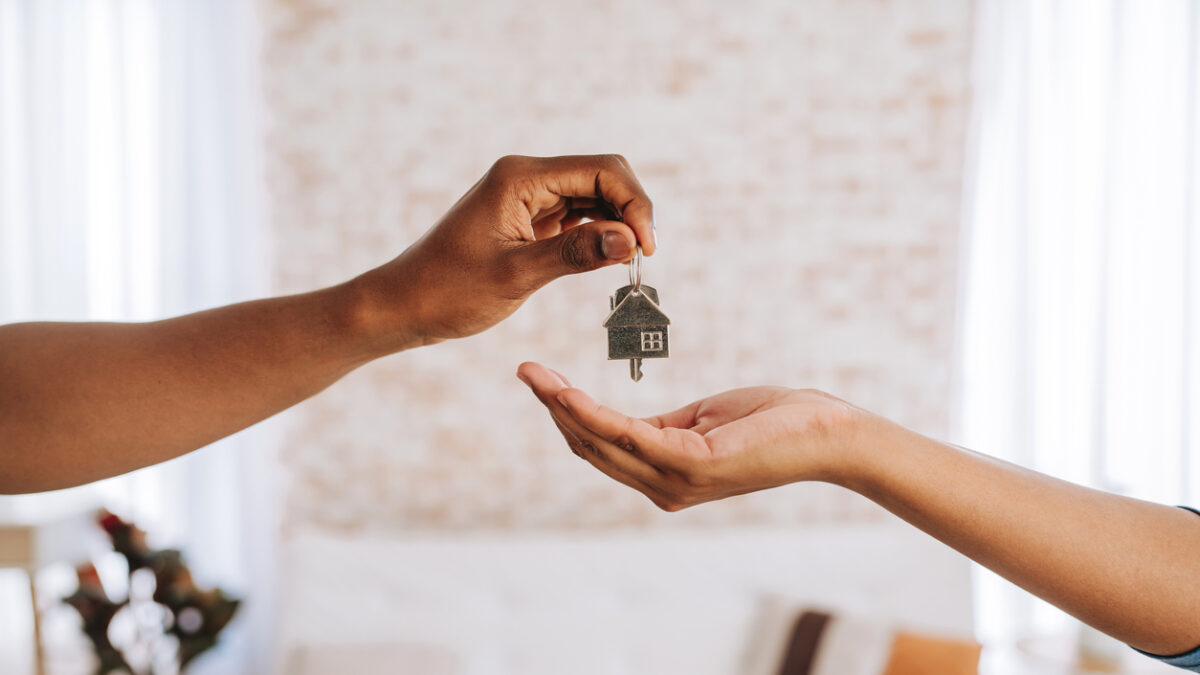 Real estate agent giving a man the keys to his new home