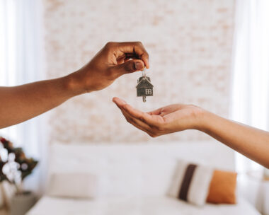 Real estate agent giving a man the keys to his new home