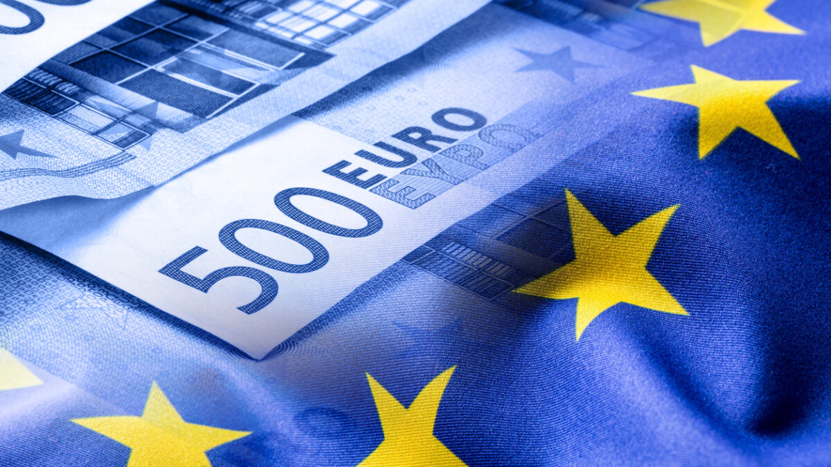 Euro flag. Euro money. Euro currency. Colorful waving european union flag on a euro money background.Euro flag. Euro money. Euro currency. Colorful waving european union flag on a euro money background