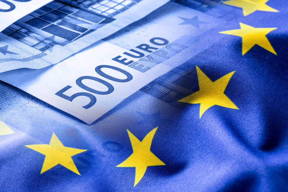 Euro flag. Euro money. Euro currency. Colorful waving european union flag on a euro money background.Euro flag. Euro money. Euro currency. Colorful waving european union flag on a euro money background