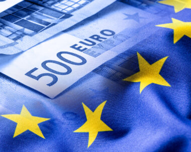 Euro flag. Euro money. Euro currency. Colorful waving european union flag on a euro money background.Euro flag. Euro money. Euro currency. Colorful waving european union flag on a euro money background